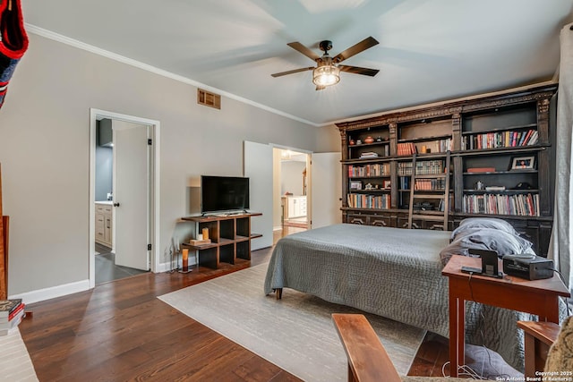 bedroom featuring ensuite bath, ornamental molding, visible vents, wood finished floors, and baseboards