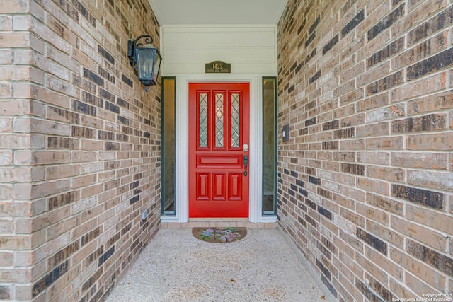 property entrance with brick siding