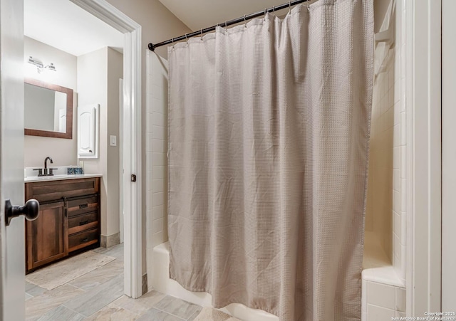 bathroom featuring shower / tub combo and vanity