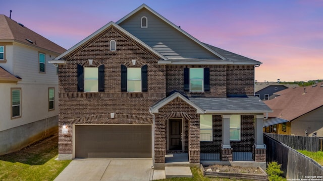 29991 Jove, Bulverde, TX 78163 - traditional-style house featuring an attached garage, covered porch, fence, brick siding, and driveway