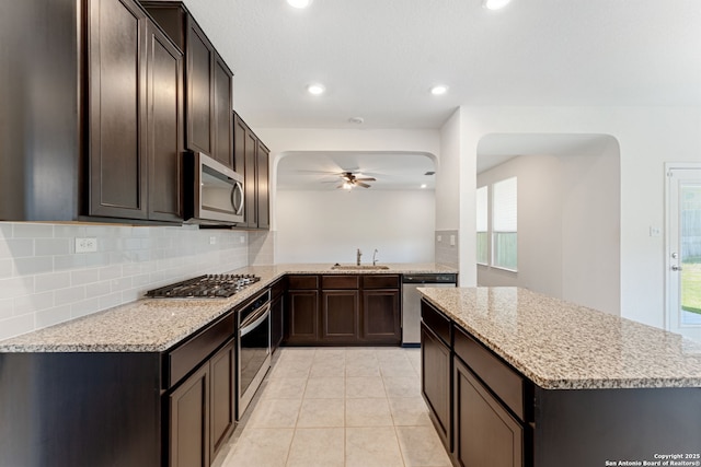 29991 Jove, Bulverde, TX 78163 - kitchen featuring arched walkways, tasteful backsplash, ceiling fan, and appliances with stainless steel finishes