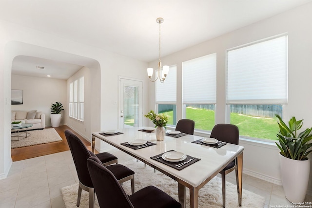 29991 Jove, Bulverde, TX 78163 - dining space with a chandelier, arched walkways, light tile patterned floors, and baseboards