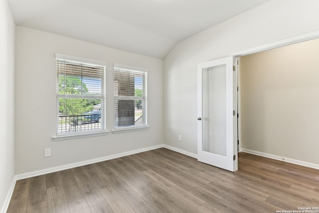 10214 King Robert, San Antonio, TX 78239 - unfurnished room with wood finished floors, vaulted ceiling, and baseboards