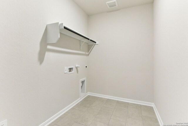 10214 King Robert, San Antonio, TX 78239 - laundry area featuring gas dryer hookup, hookup for a washing machine, hookup for an electric dryer, light tile patterned floors, and baseboards