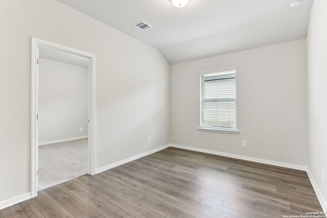 10214 King Robert, San Antonio, TX 78239 - empty room with lofted ceiling, wood finished floors, and baseboards