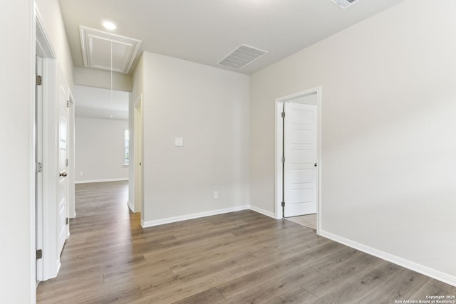 10214 King Robert, San Antonio, TX 78239 - unfurnished room with attic access, wood finished floors, and baseboards