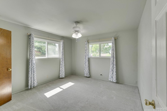 unfurnished room featuring carpet and plenty of natural light