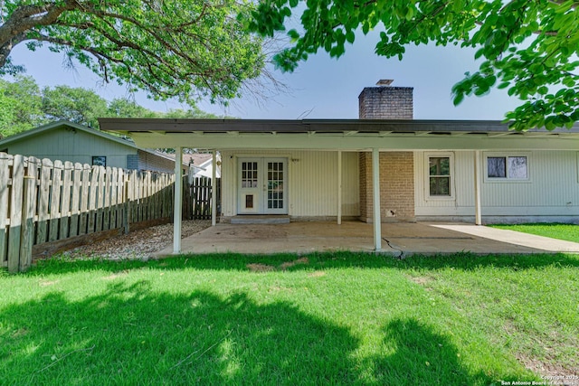 rear view of property with a patio area, french doors, a fenced backyard, and a chimney