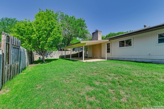 view of yard with a patio area and a fenced backyard