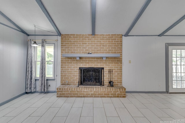 unfurnished living room featuring a fireplace and lofted ceiling with beams