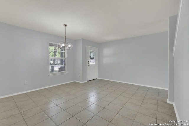 interior space featuring an inviting chandelier, baseboards, and light tile patterned floors