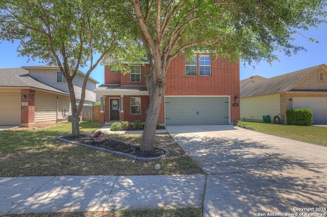 traditional home with brick siding, driveway, and an attached garage