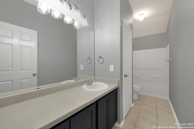 full bathroom featuring vanity, baseboards, tile patterned floors, a bathing tub, and toilet