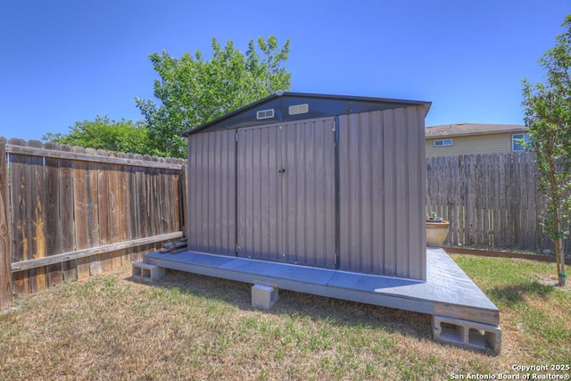 view of shed with a fenced backyard