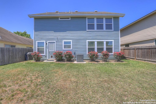 rear view of property with a yard, a fenced backyard, and cooling unit