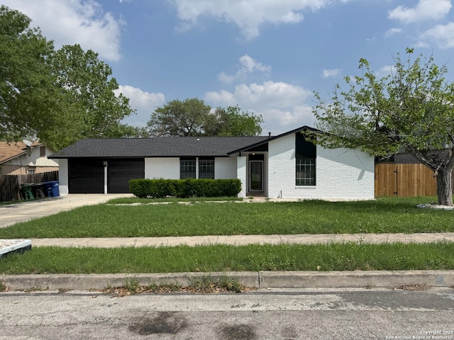 2410 Townbreeze, San Antonio, TX 78238 - view of front facade featuring driveway, an attached garage, a front lawn, brick siding, and fence