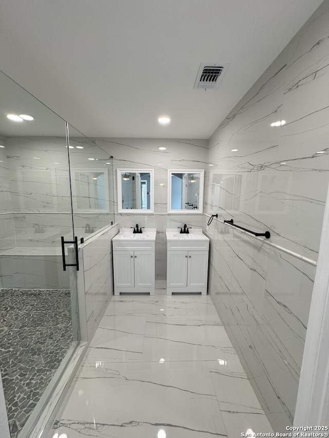 2410 Townbreeze, San Antonio, TX 78238 - bathroom featuring two vanities, recessed lighting, a marble finish shower, visible vents, and marble finish floor