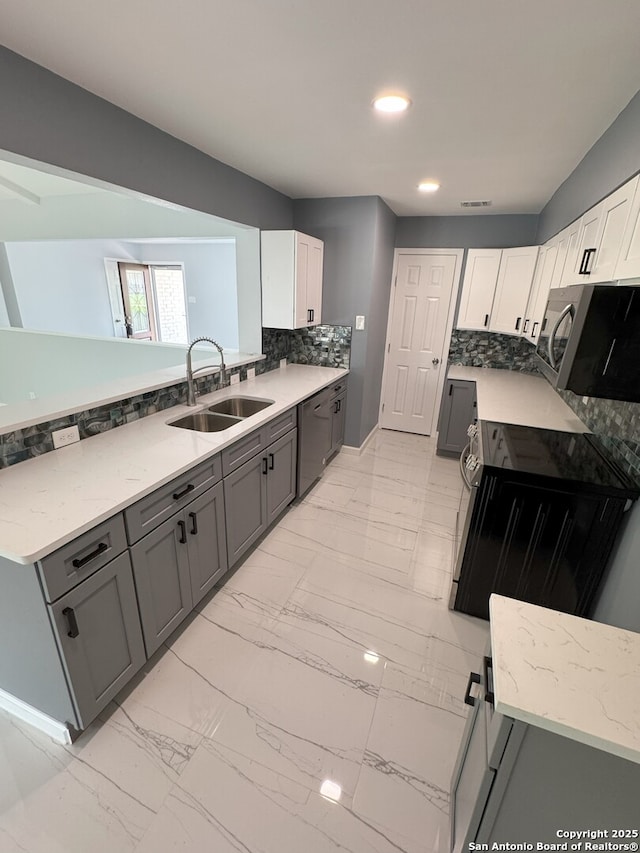 2410 Townbreeze, San Antonio, TX 78238 - kitchen featuring light stone counters, marble finish floor, a sink, dishwasher, and decorative backsplash