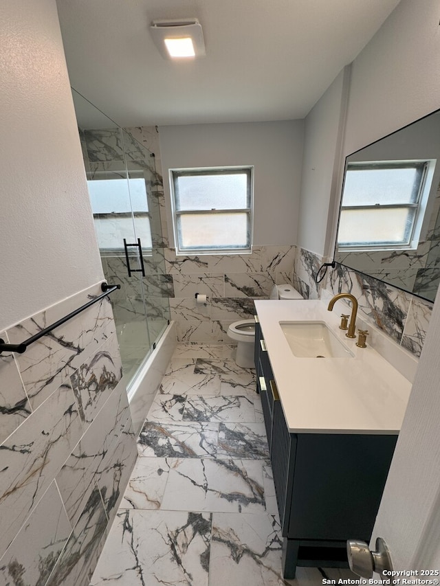 2410 Townbreeze, San Antonio, TX 78238 - bathroom featuring shower / bath combination with glass door, vanity, marble finish floor, and toilet