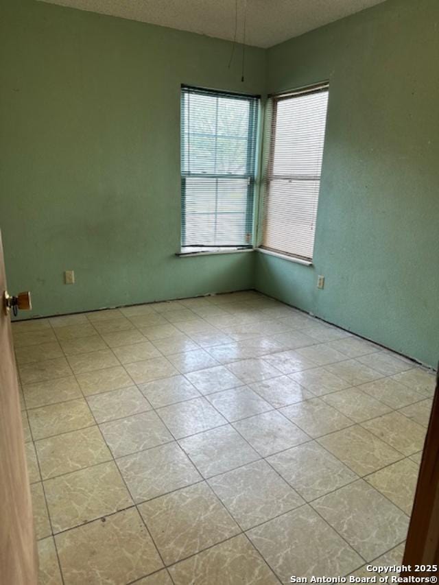 726 Southcross, San Antonio, TX 78211 - spare room featuring a textured ceiling and light tile patterned flooring