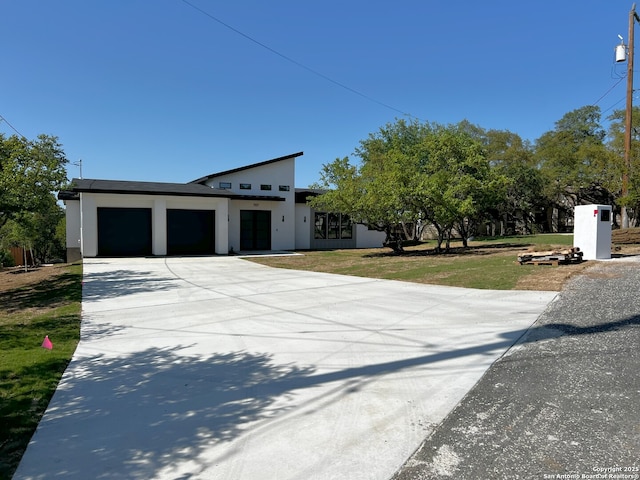 707 Lone Cir, San Antonio, TX 78260 - view of front facade featuring a garage, a front yard, driveway, and stucco siding