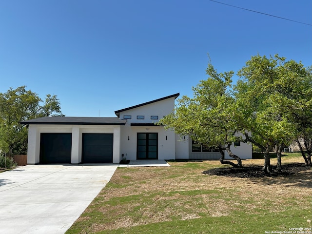 707 Lone Cir, San Antonio, TX 78260 - contemporary house with driveway, stucco siding, an attached garage, and a front lawn