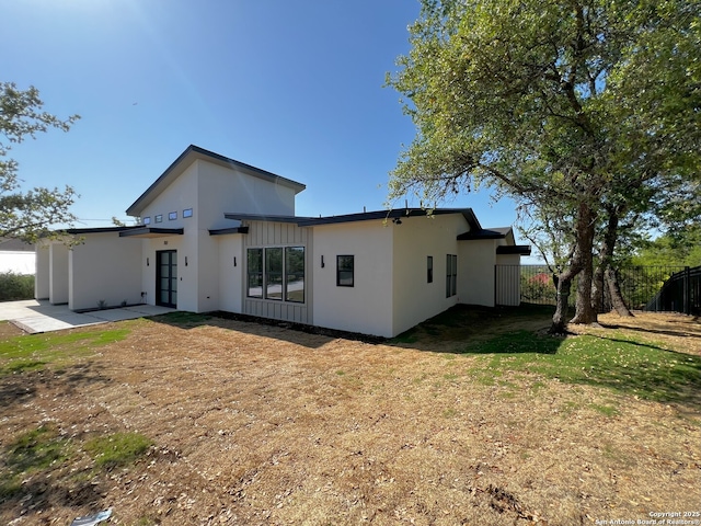 707 Lone Cir, San Antonio, TX 78260 - view of front facade with board and batten siding, fence, a patio, stucco siding, and a front lawn