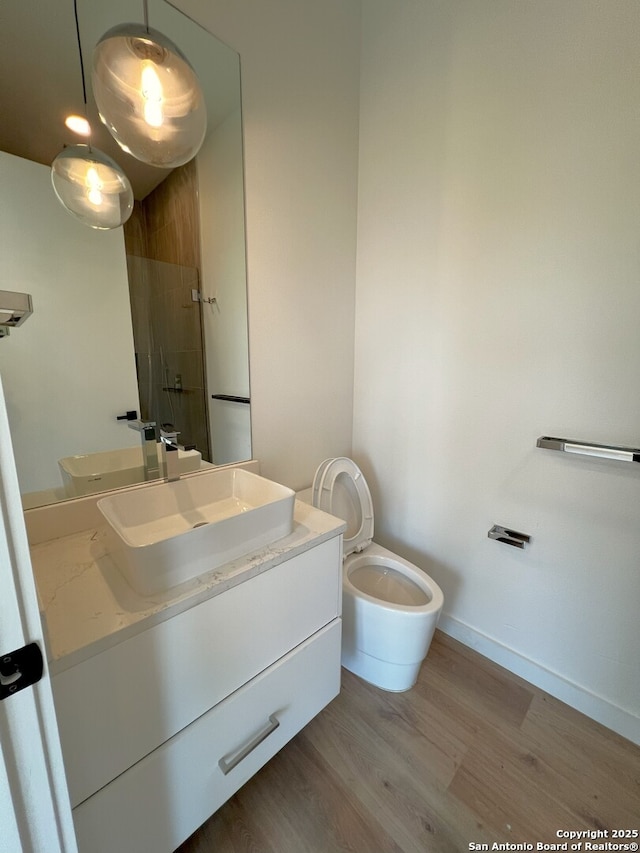 707 Lone Cir, San Antonio, TX 78260 - full bathroom with vanity, baseboards, toilet, a shower stall, and wood finished floors