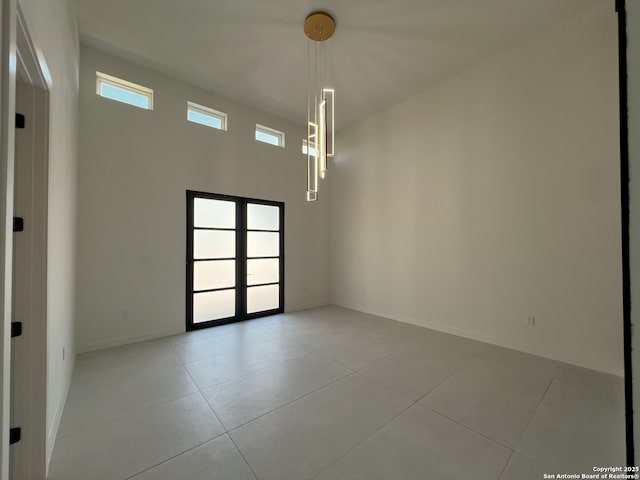 707 Lone Cir, San Antonio, TX 78260 - unfurnished room featuring light tile patterned floors, french doors, and baseboards