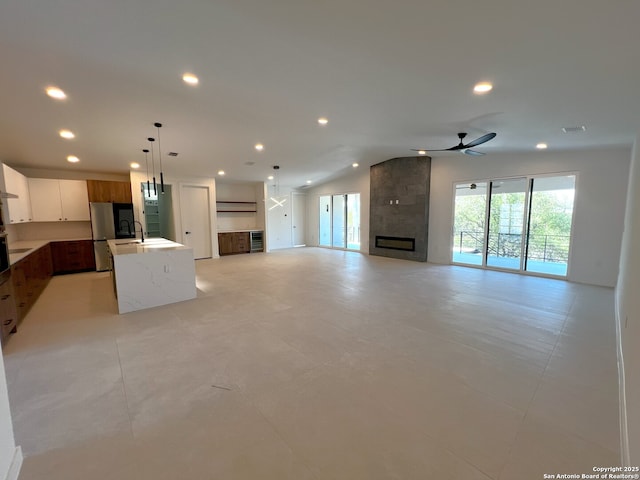707 Lone Cir, San Antonio, TX 78260 - unfurnished living room with a ceiling fan, recessed lighting, a sink, and a fireplace
