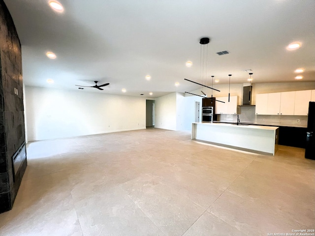 707 Lone Cir, San Antonio, TX 78260 - unfurnished living room with recessed lighting, finished concrete flooring, visible vents, ceiling fan, and a sink