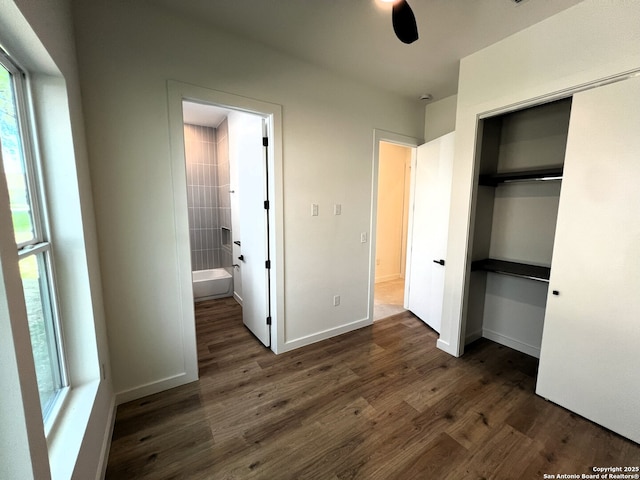 707 Lone Cir, San Antonio, TX 78260 - unfurnished bedroom featuring a closet, baseboards, ensuite bath, and dark wood-style floors