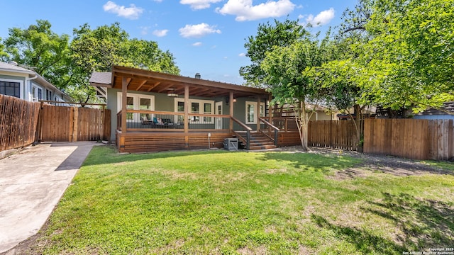315 Carnahan, San Antonio, TX 78209 - rear view of property featuring a yard, a fenced backyard, a deck, and concrete driveway