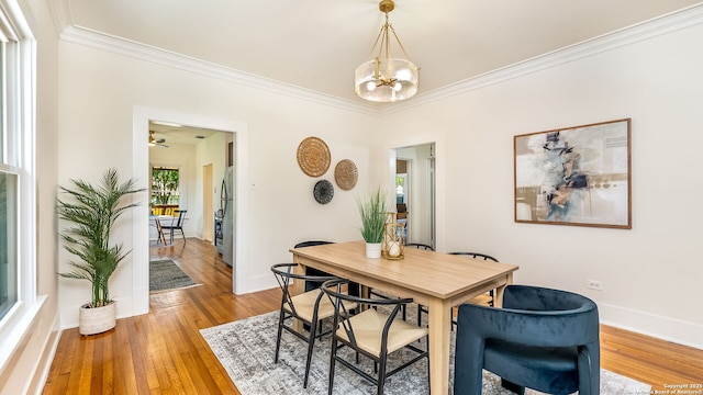 315 Carnahan, San Antonio, TX 78209 - dining area featuring light wood-style flooring, ornamental molding, baseboards, and an inviting chandelier