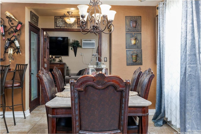 dining space featuring light tile patterned floors, a wall mounted air conditioner, a chandelier, a textured wall, and baseboards