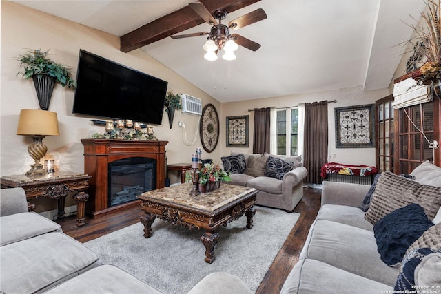 living area featuring lofted ceiling with beams, a ceiling fan, wood finished floors, a glass covered fireplace, and a wall unit AC