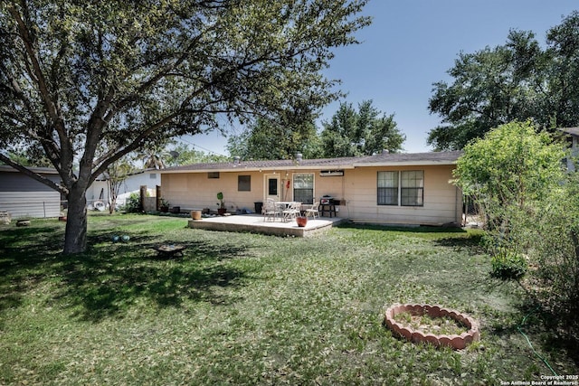 rear view of house with a patio and a yard