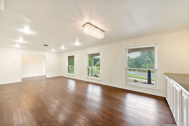 3918 Midvale, San Antonio, TX 78229 - spare room with ornamental molding, dark wood-type flooring, baseboards, and a chandelier