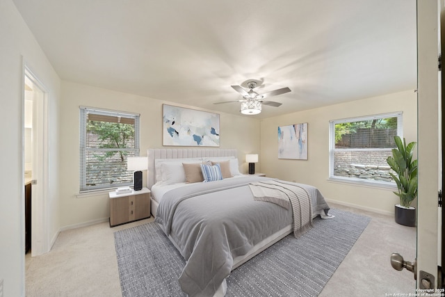 3918 Midvale, San Antonio, TX 78229 - bedroom with light carpet, multiple windows, baseboards, and a ceiling fan