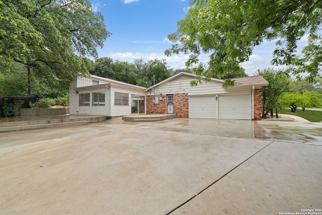 3918 Midvale, San Antonio, TX 78229 - view of front facade featuring brick siding, a garage, and concrete driveway