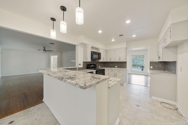 3918 Midvale, San Antonio, TX 78229 - kitchen featuring black appliances, a peninsula, decorative backsplash, white cabinetry, and light stone counters