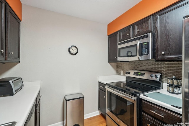 4111 Medical Dr Unit A 204, San Antonio, TX 78229 - kitchen with appliances with stainless steel finishes, backsplash, light countertops, baseboards, and light wood-style floors
