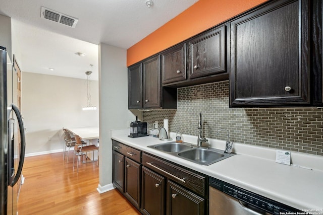 4111 Medical Dr Unit A 204, San Antonio, TX 78229 - kitchen featuring a sink, black fridge, dishwasher, backsplash, and baseboards