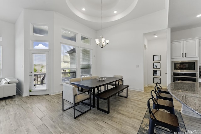 1105 Limestone, New Braunfels, TX 78132 - dining area featuring baseboards, a chandelier, recessed lighting, light wood-style flooring, and a high ceiling
