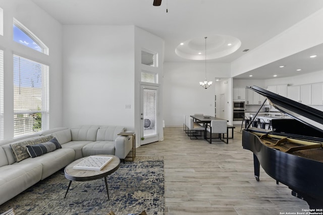 1105 Limestone, New Braunfels, TX 78132 - living area featuring recessed lighting, light wood-style flooring, a high ceiling, and ceiling fan with notable chandelier