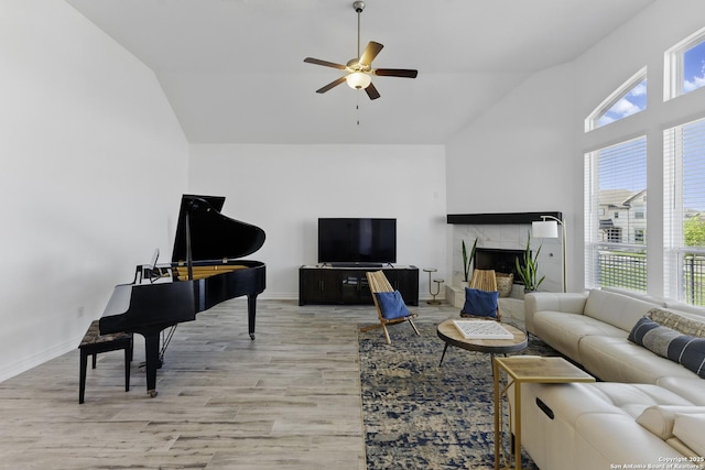 1105 Limestone, New Braunfels, TX 78132 - living area with light wood-style floors, high vaulted ceiling, a ceiling fan, a tile fireplace, and baseboards