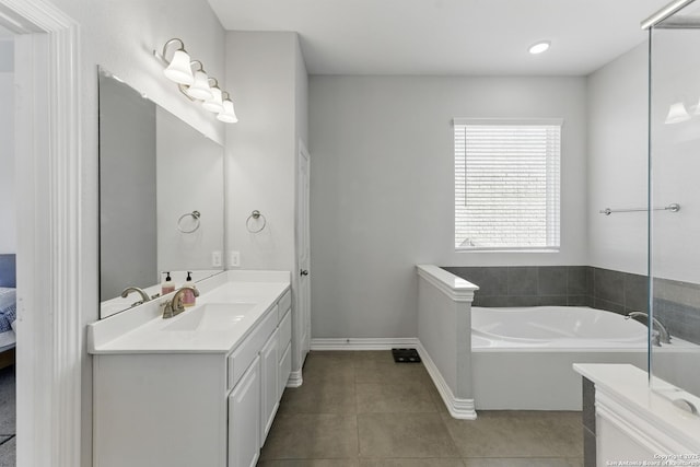 1105 Limestone, New Braunfels, TX 78132 - ensuite bathroom with baseboards, connected bathroom, vanity, tile patterned floors, and a garden tub