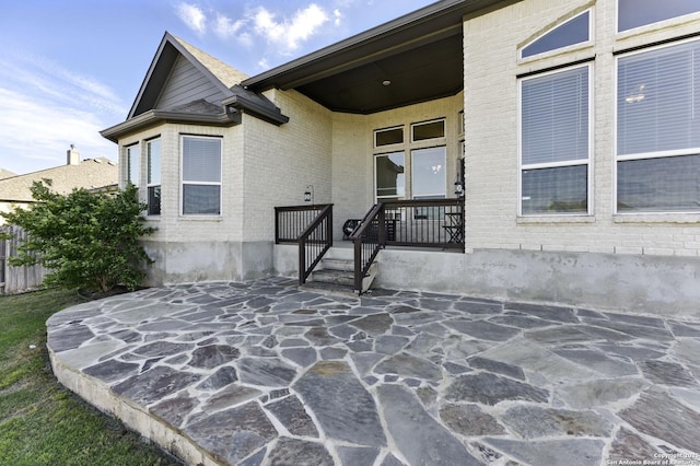 1105 Limestone, New Braunfels, TX 78132 - doorway to property featuring brick siding and a patio area