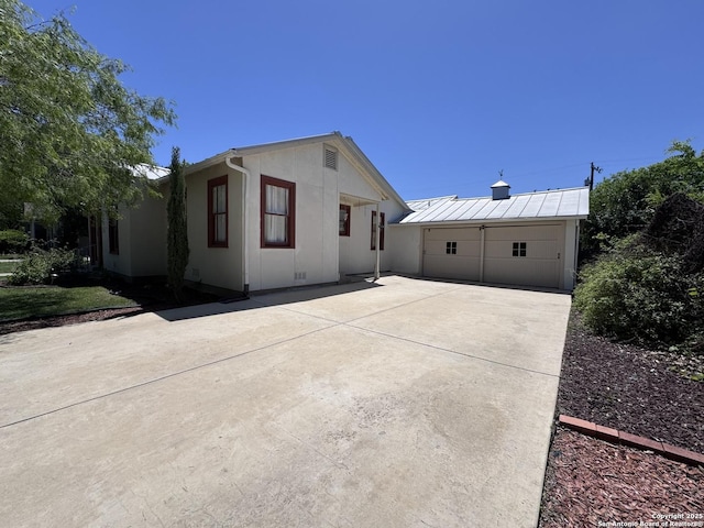 exterior space featuring a patio and a detached garage