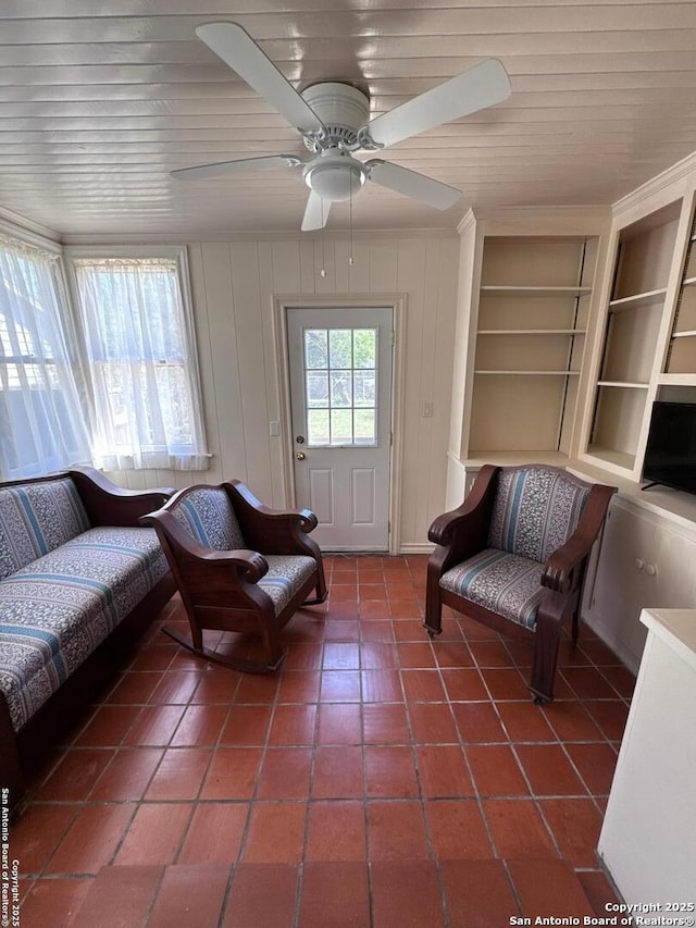 living room featuring tile patterned floors, built in shelves, wooden ceiling, and ceiling fan